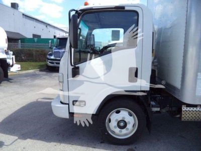 Isuzu NPR box truck front left view showing cab and side mirror with wheel and cargo box in background.