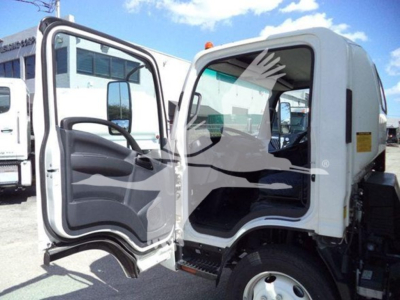 Isuzu NPR truck cab with driver door open showing interior and steps.