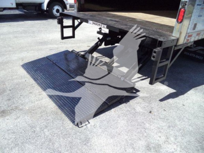 Isuzu NPR truck with a side-mounted hydraulic lift/ ramp in a loading platform, showing perforated metal ramp extended from truck bed