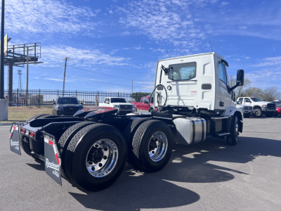Mack AN64T conventional daycab tractor showing side view with tandem rear axles and white cab.