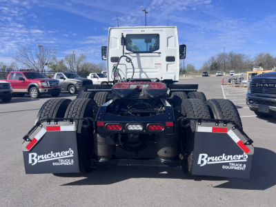 Truck rear view showing chassis and mud flaps with Bruckner's Truck & Equipment logo and dual rear axles on a Mack AN64T.