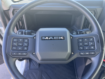 Mack AN64T steering wheel with control buttons on both sides and Mack logo center.