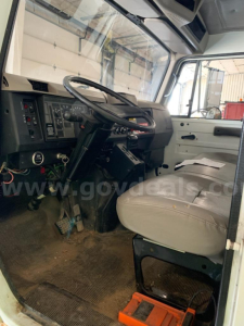 Interior of a 2000 International 4700 cab showing steering wheel and dash area.