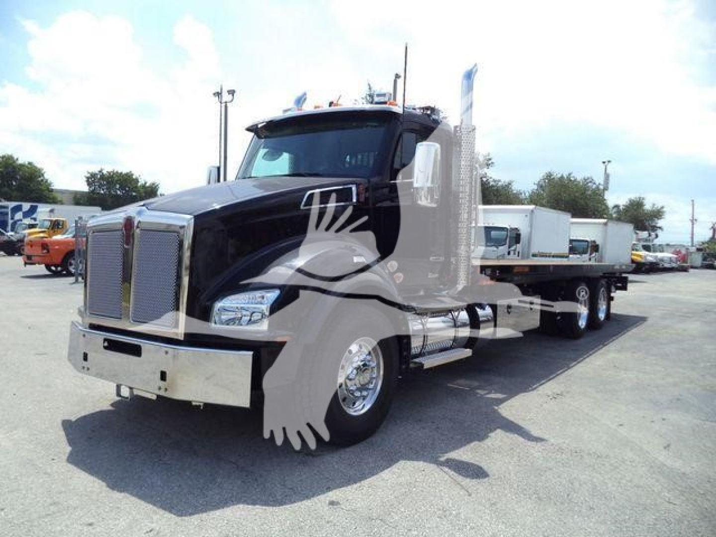 Truck oriented front-left showing a black Kenworth T880 chassis cab with chrome grille and flatbed; stock number J11613FM in a dealership lot.