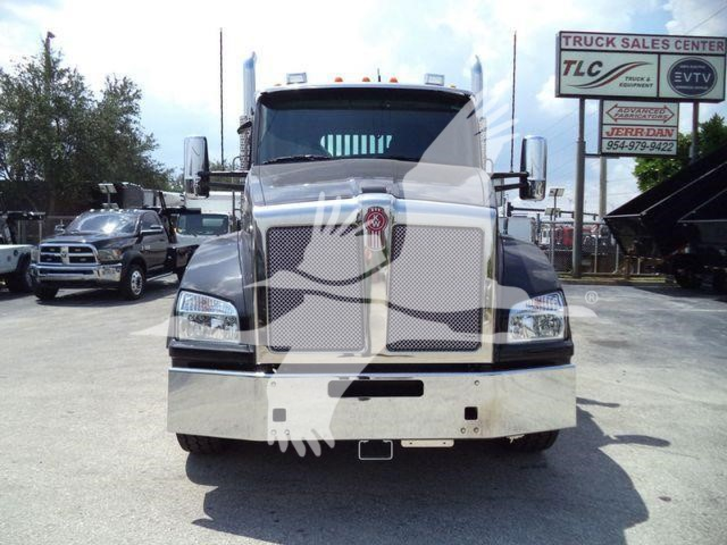 Truck front view of a 2026 Kenworth T880 in a dealership lot showing chrome grille and bumper