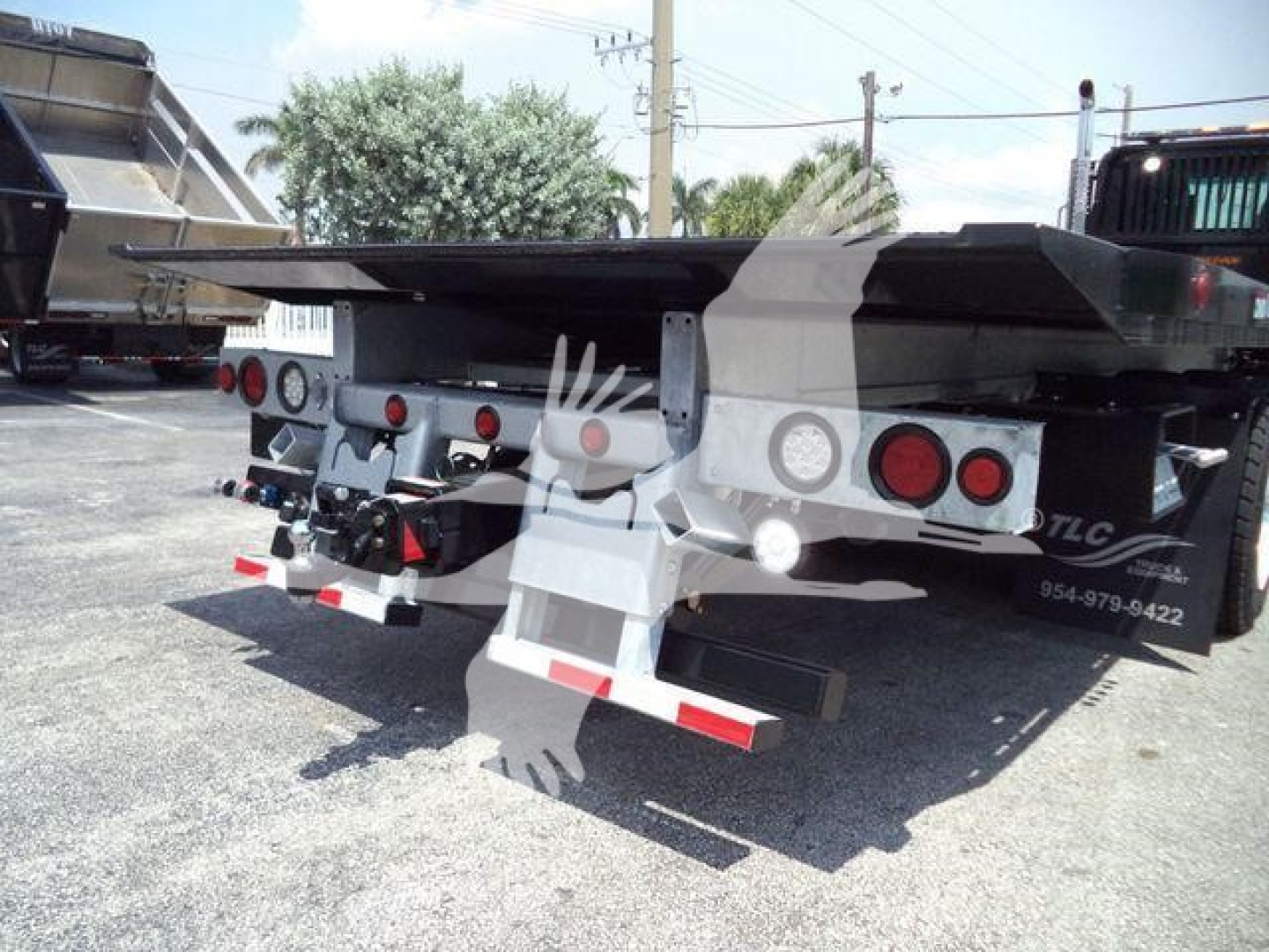 Rear view of a new Kenworth T880 rollback bed trailer showing deck and taillight assemblies.