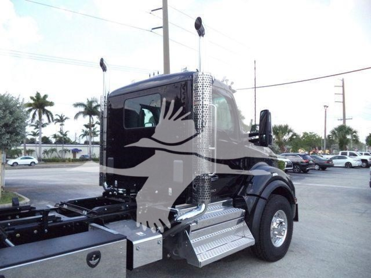 Kenworth T880 truck cab in view from side showing front wheel, chrome diamond-plate steps, and fuel/air lines with ‘Kenworth’ badge. Rollback configuration image.