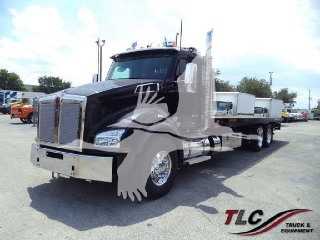 Kenworth T880 truck in a rollback configuration showing front grille, cab, and dual rear axles with chrome exhaust stacks.