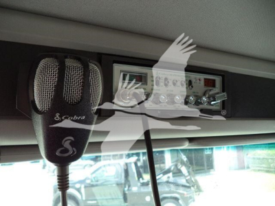 Kenworth T880 interior view showing a Cobra micro handheld mic and a control panel mounted overhead.