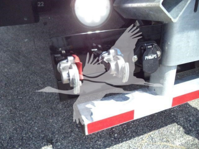 Kenworth T880Rollback component close-up showing electrical connectors, Phillips oil reservoir cap, and trailer hitch area.