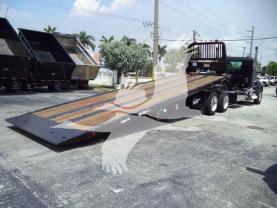 Kenworth T880 rollback truck with long flatbed and winch system, shown from front-left view.