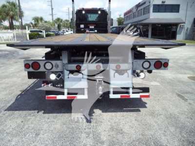 Kenworth T880 rollback flatbed truck rear view showing platform and taillights.