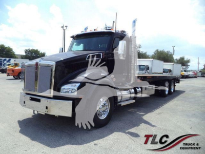 Kenworth T880 truck in a rollback configuration showing front grille, cab, and dual rear axles with chrome exhaust stacks.
