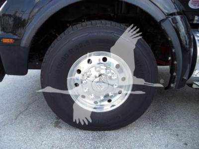 Kenworth T880 front wheel and fender showing tire and polished chrome wheel