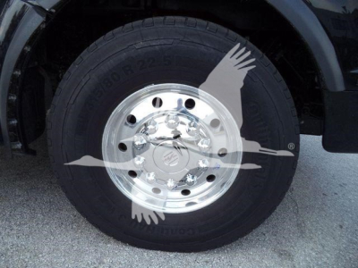 Truck wheel with polished aluminum rim and black tire in-view