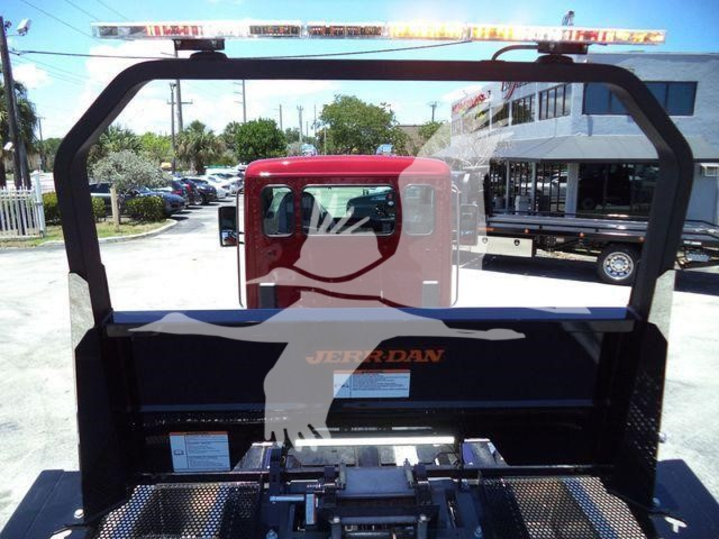 Kenworth T280 rollback truck bed with rear cab window view and metal frame, no visible text on side panels.