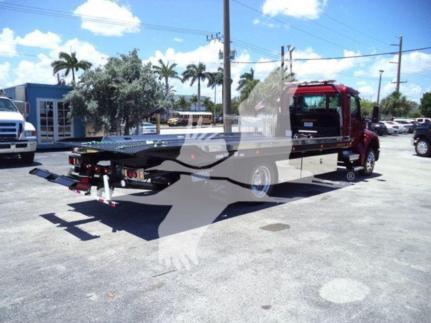 Kenworth T280 rollback truck in service position showing flatbed and wheel-lift equipment.
