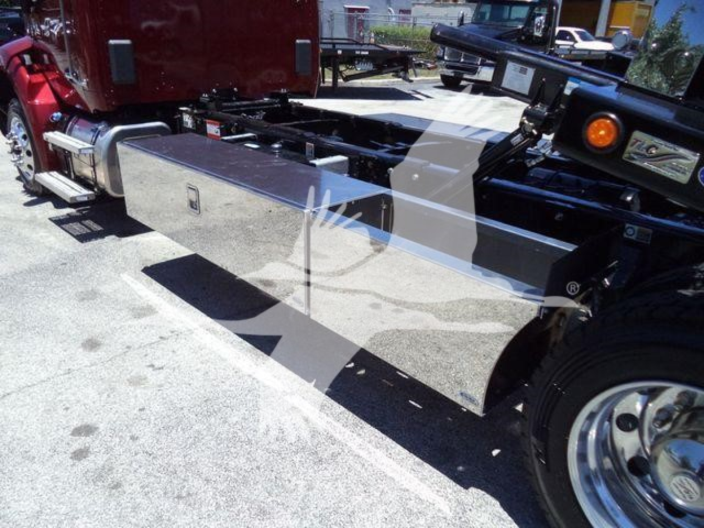 Kenworth T280 rollback truck chassis and fuel/tool box visible in the cargo area.