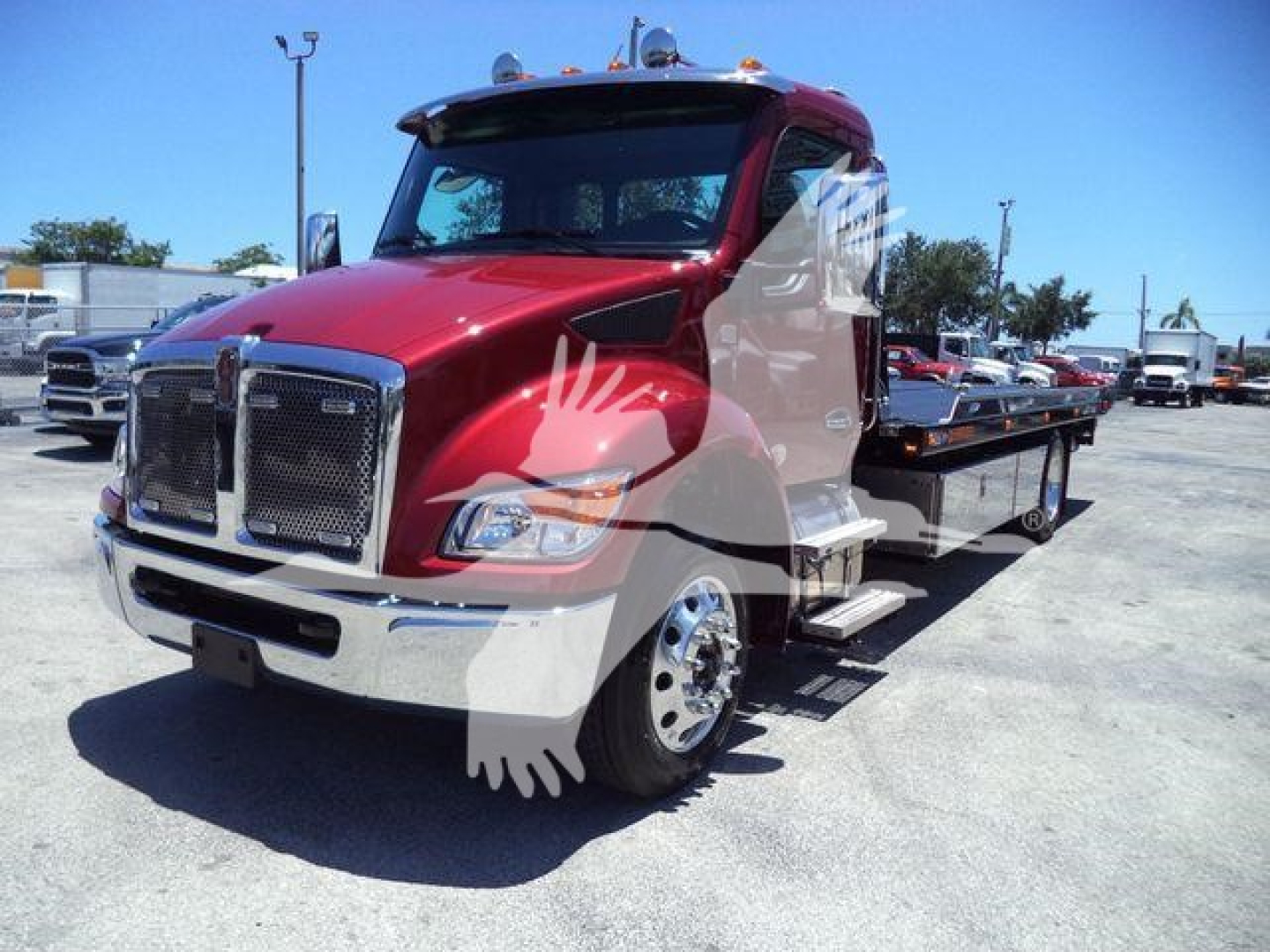 Kenworth T280 rollback truck in red with a flatbed, front grille, and chrome bumper.
