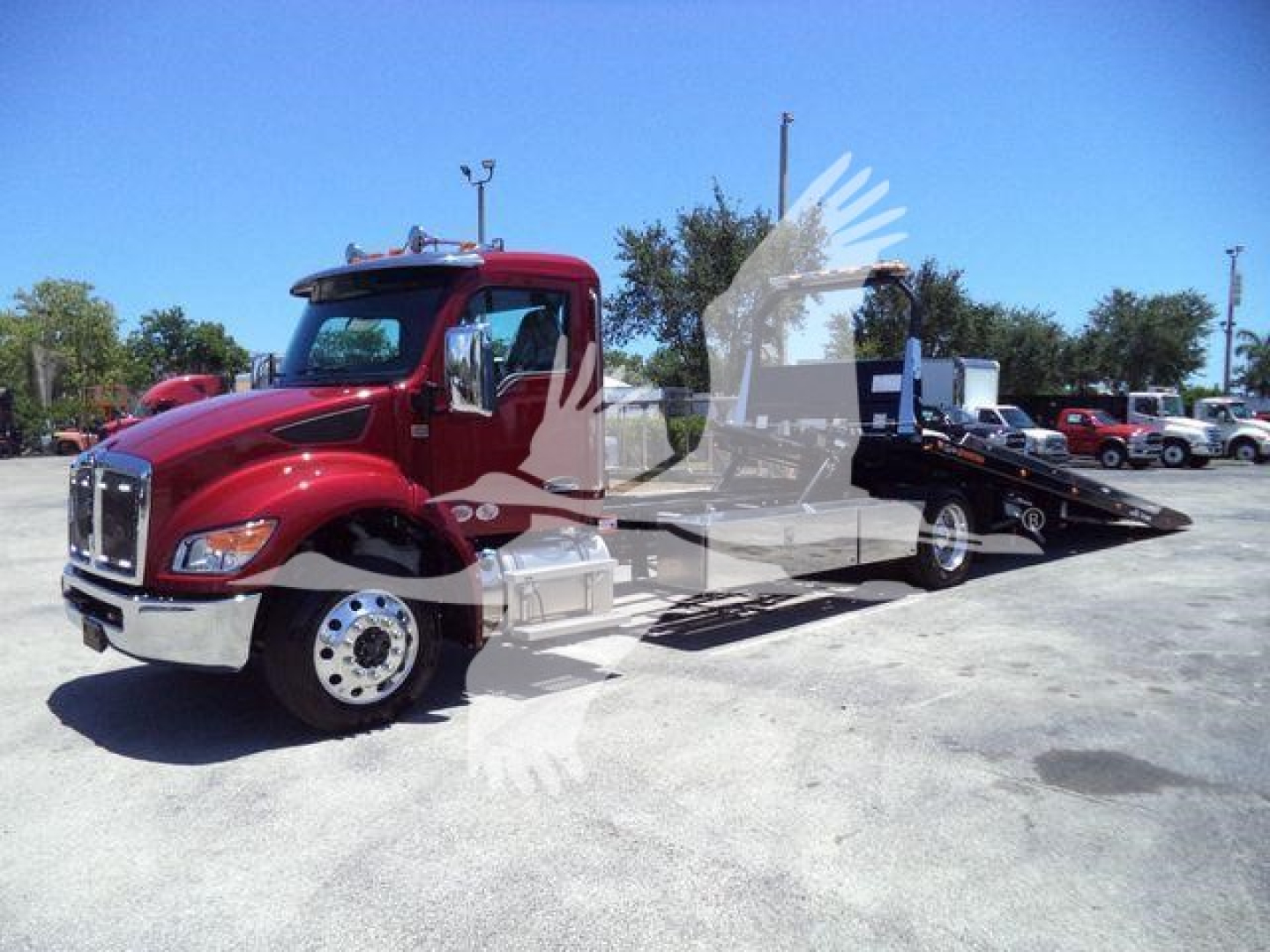 Kenworth T280 rollback tow truck in red and black with flatbed, side view showing cab and wheels