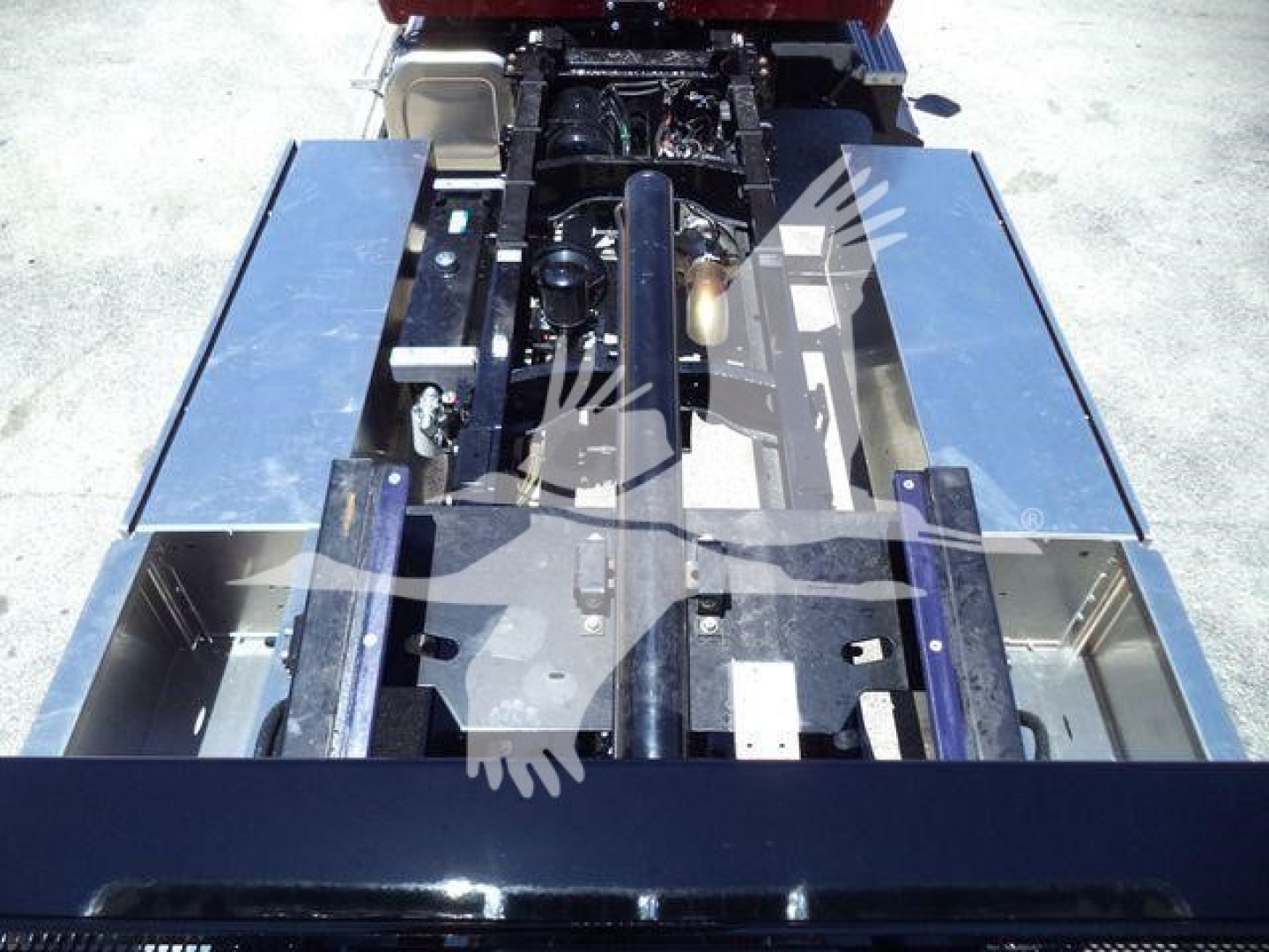Kenworth T280 rollback truck chassis showing engine area and metal frame rails with components visible.