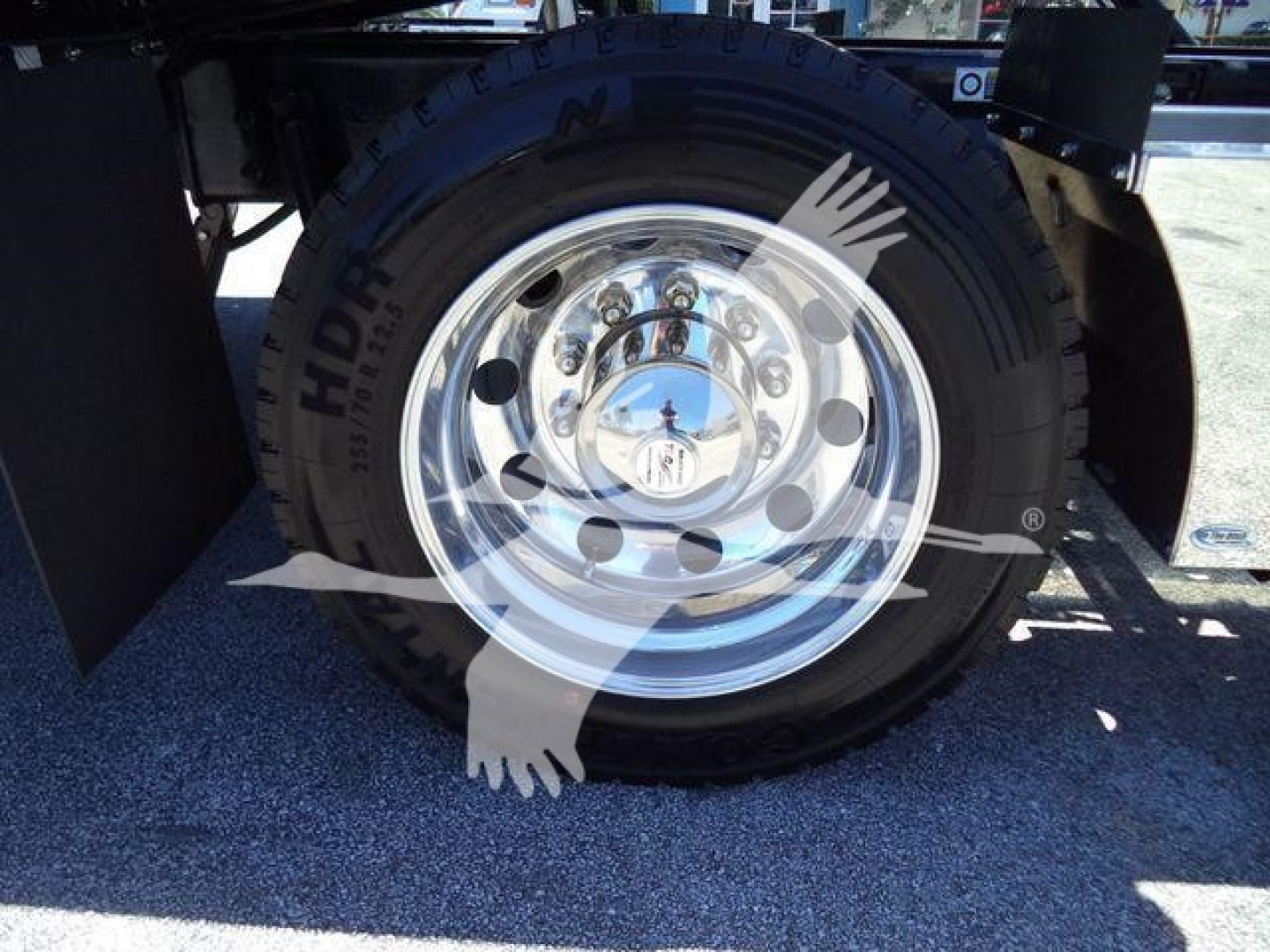 Kenworth T680/T880 front wheel hub and tire showing chrome wheel and FHDI tires in rollback truck chassis.