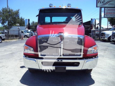 Front view of a red 2025 Kenworth T280 truck with chrome grille and bumper, large rectangular grille, dual large side mirrors, daytime running lights, and a black license plate area.