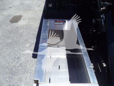 Kenworth T280 rollback truck bed showing metal toolbox/step area with bolts and warning label visible.