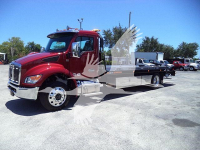 Kenworth T280 rollback truck in red with flatbed, side view showing cab and long rear deck.
