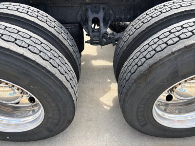 Kenworth T680 rear dual-drive axle area with wheels and suspension components visible; no text legible on image aside from wheel rims.