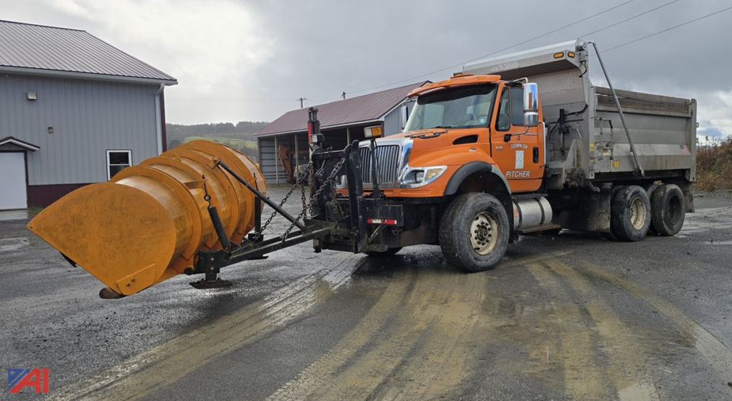 Dump truck with plow attachment, orange International WorkStar 7600, side view showing large front snow plow and mounted dump bed.