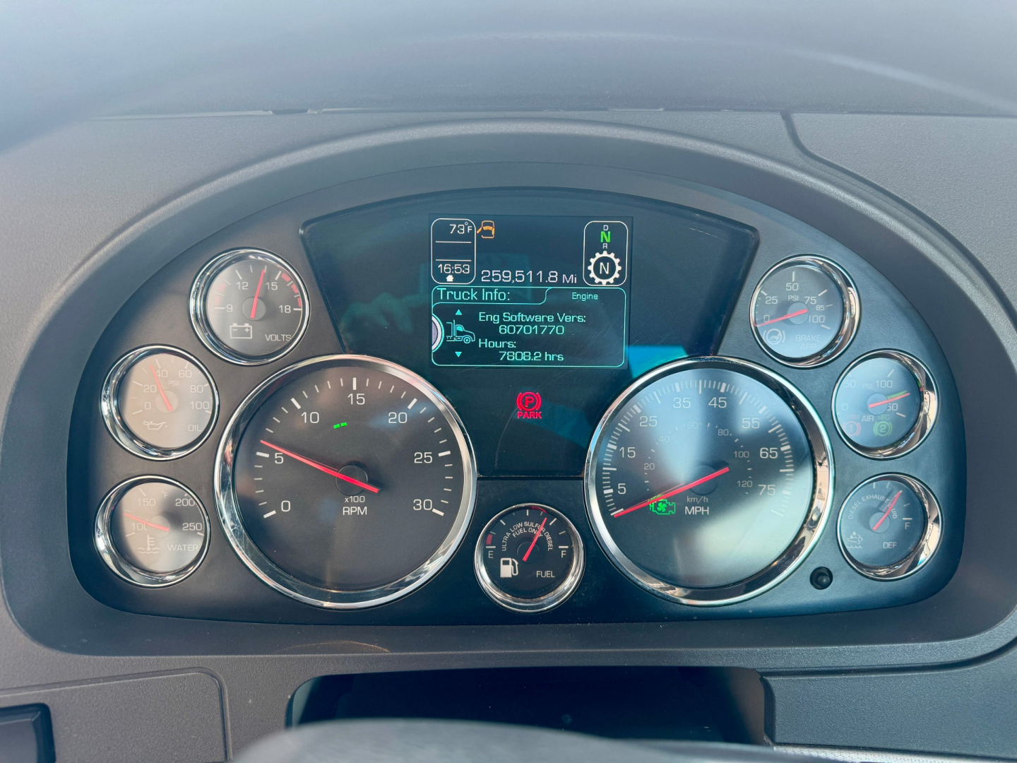 Kenworth T680 dash cluster and gauge panel showing digital display with vehicle info and multiple round gauges.