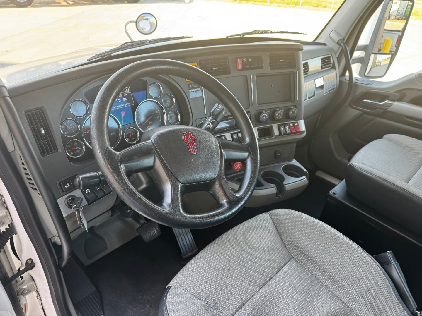Kenworth T680 interior cab showing steering wheel with emblem and dashboard gauges