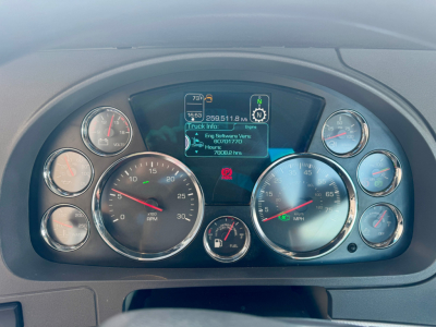 Kenworth T680 dash cluster and gauge panel showing digital display with vehicle info and multiple round gauges.