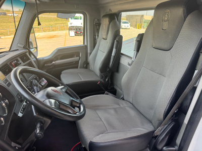 Kenworth interior cab view showing driver and passenger seats, steering wheel, and dashboard in a 2020 T680 truck.