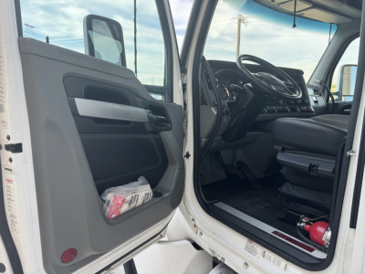 Kenworth T680 cab interior with open driver's door showing steering wheel, dashboard, and seat; VIN/stock info not visible in image.