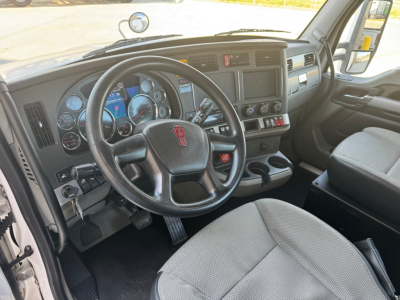 Kenworth T680 interior cab showing steering wheel with emblem and dashboard gauges