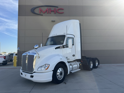 Kenworth T680 tractor in white, day cab, front and side view showing chrome grille, fuel tanks, dual rear axles, and sleeper cab with high roof.