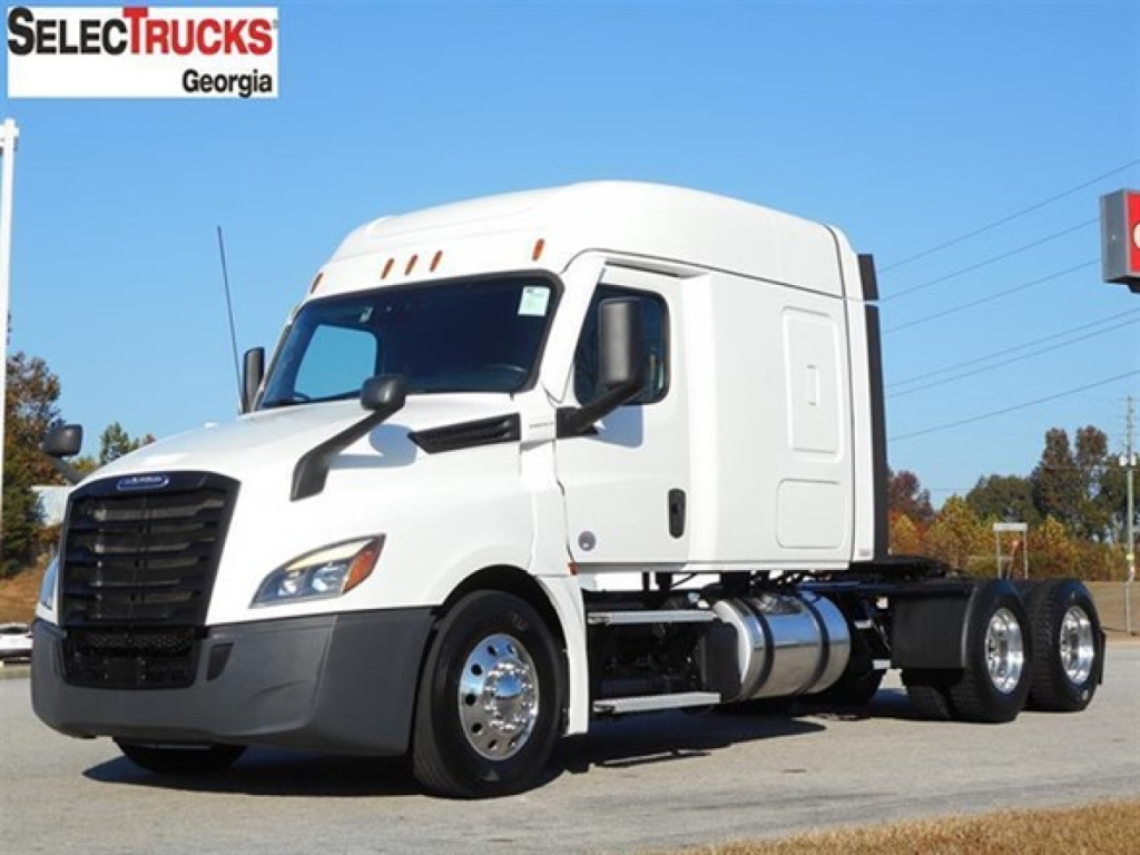 Freightliner Cascadia 126 truck in white, side view showing sleeper cab and front grille, with SelectTrucks Georgia logo visible.