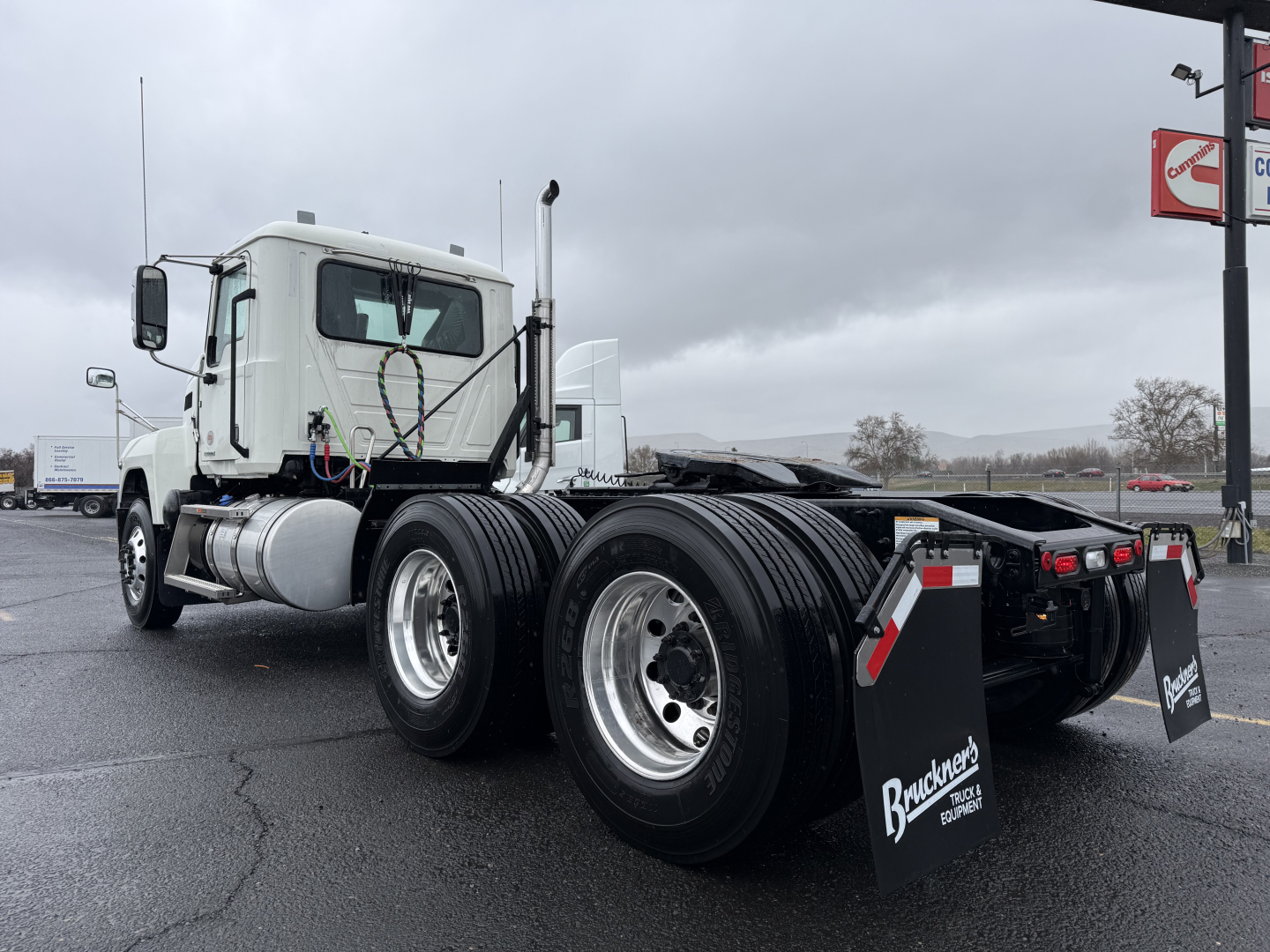 Truck chassis of a 2026 Mack PI64T conventional daycab showing dual rear axles and fuel tanks.