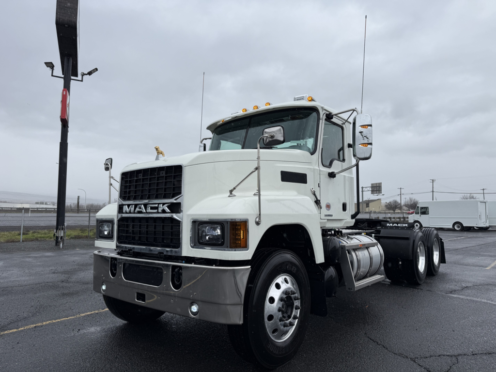 Mack PI64T conventional daycab truck showing front view with white exterior and large grille