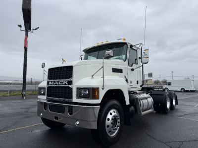 Mack PI64T conventional daycab truck showing front view with white exterior and large grille