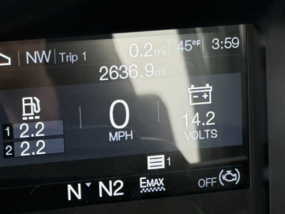 Dashboard screen of a 2026 Mack PI64T showing trip data: 0 mph, 14.2 volts, 2636.9 mi total, 0.2 mi trip, exterior temps 45°F, time 3:59, gear N’N2, two axle readouts 2.2 and 2.2, EMAX, OFF indicators.