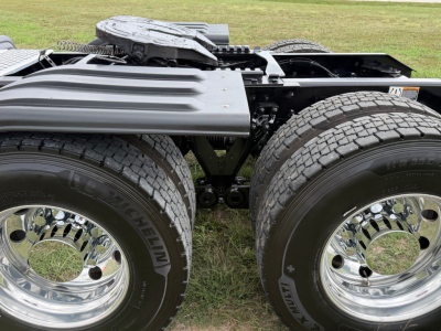 Kenworth T680 chassis with dual rear axles and Michelin tires, chrome wheels, visible frame and fifth-wheel area.