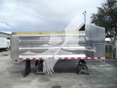 Dump box trailer with metal side panels and wooden trim showing dual rear steel stands and reflective safety tape.