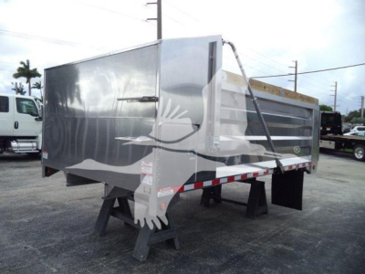 Dump trailer in aluminum with 14 ft length showing ADFAB14FTALUM1 stock number and New/Used category; reflective safety stripes on sides.