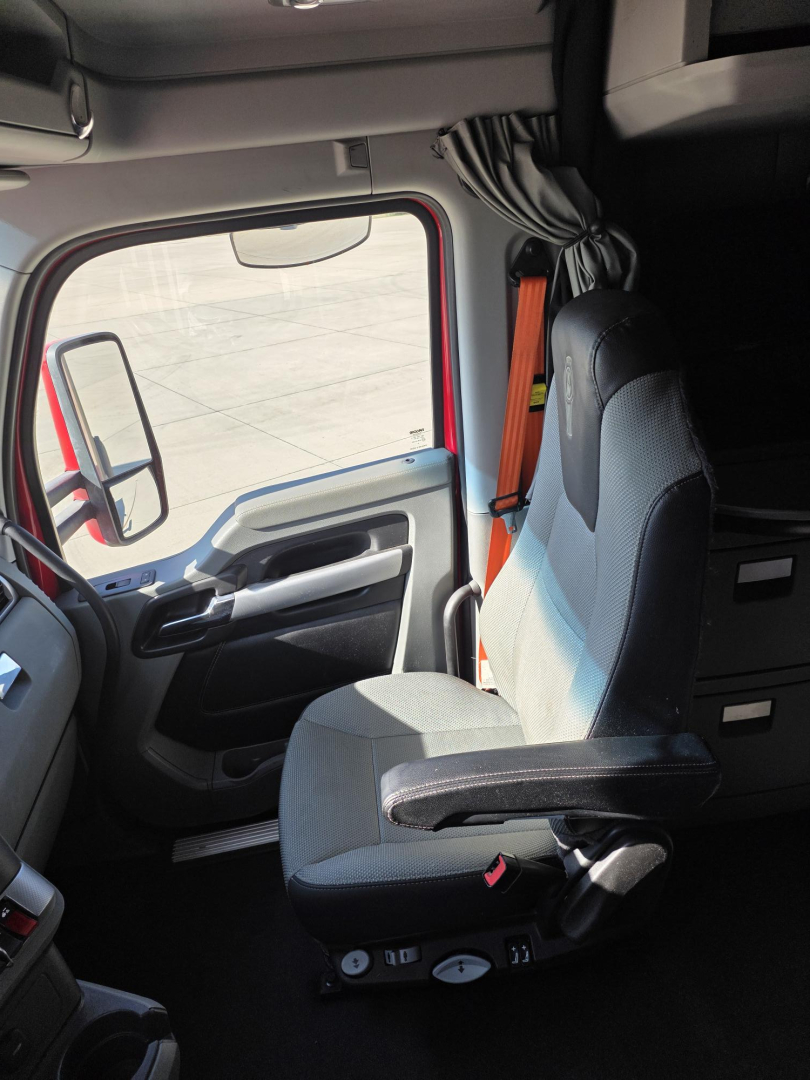 Kenworth T680 cab interior showing driver seat and dashboard in view.