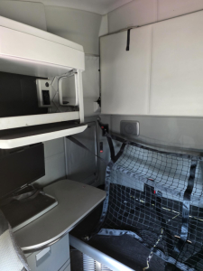 Kenworth cab interior showing sleeper storage and netting.