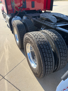 Kenworth T680 rear dual-axle trailer tires and chassis with fuel/wiring visible, 2022 Kenworth T680 listing image.
