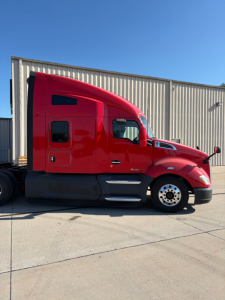 Red 2022 Kenworth T680 semi-truck in side profile view showing sleeper cab, chrome wheels, and streamlined front end.